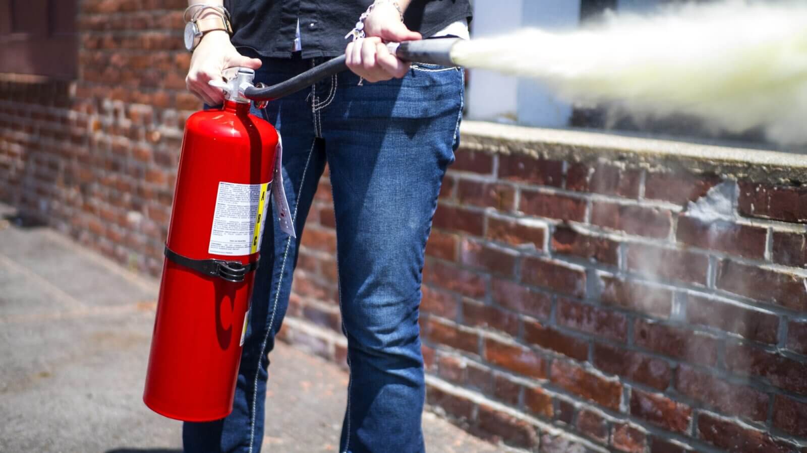 a man using Fire Extinguishers